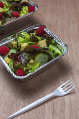 Healthy vegan take away salad in aluminum container