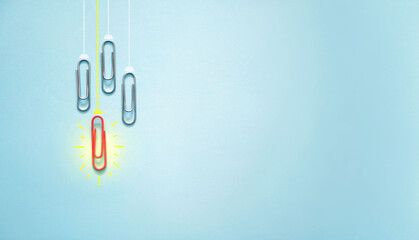 New ideas concept with paperclip light bulb on blue background. Innovation, creativity, inspiration, thinking outside the box and solution concepts. 