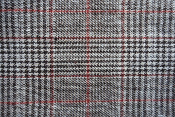 Top view of gray and red Glen check fabric