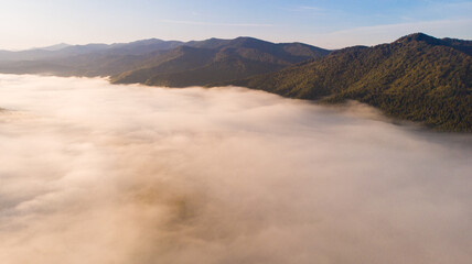 Bird eye aerial view of cloudy foggy mountains landscape view with sunrise 