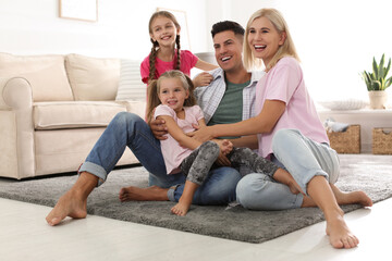 Portrait of happy family on floor at home