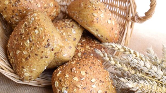 Home baked bread. Rye bakery with crusty loaves and crumbs. Fresh rustic traditional bread with wheat grain ear or spike plant on natural cotton background. Design element for bakery product label