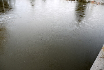 pool in the park holding ice, icy water pools in the winter,