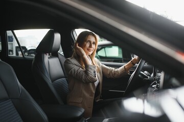 beautiful woman sitting at the wheel of a car