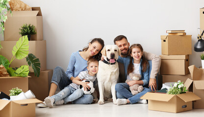 Cheerful family sitting of floor in new apartment