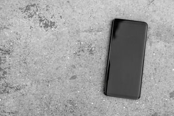 Smart phone on stained concrete background