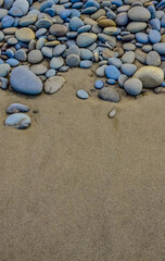 Fototapeta na wymiar Multicolored round pebble stones on the Pacific Ocean in Olympic National Park, Washington