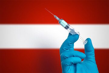 Fight against the epidemic of coronavirus  .Doctor's hand in gloves with vaccine for the treatment of the COVID-19 on the background of the flag of  Austria. Flu shot in Austria