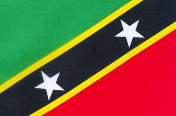 National flag of Saint Kitts and Nevis close-up on fabric base