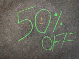 The inscription text on the grey board, 50% off. Using color chalk pieces.