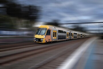 Fototapeta na wymiar Sydney Train heading through Summerhill Station with background motion blur NSW Australia
