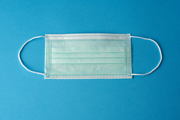 Prevent coronavirus. Medical mask, Medical protective mask on blue background. Disposable surgical...