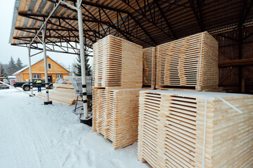 forklift truck with planks, delivery of wood to the warehouse, loading a large number of wooden planks with the help of industrial transport