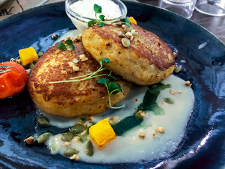 Potato pancakes stuffed with meat, sour cream, vegetable sauce