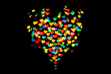 Heart-shaped multicolored bokeh on a black background.