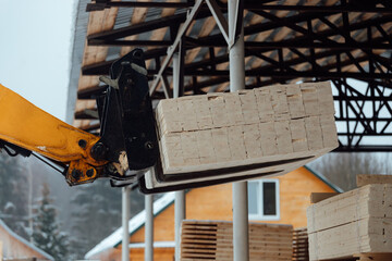 forklift truck with planks, delivery of wood to the warehouse, loading a large number of wooden...