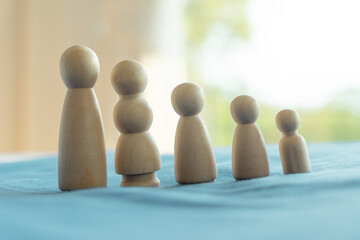 wooden figure of people in family include parents and children. togetherness concept