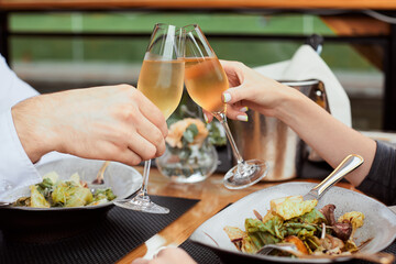couple having amazing lunch and drink champagne at outdoor restaurant
