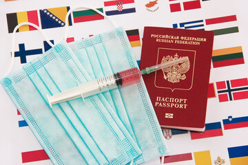 Antalya, Turkey, January 26, 2021.International Russian passport, medical masks and a syringe with a vaccine