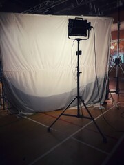 Behind the scenes of music video shooting production crew team silhouette and camera equipment in studio.