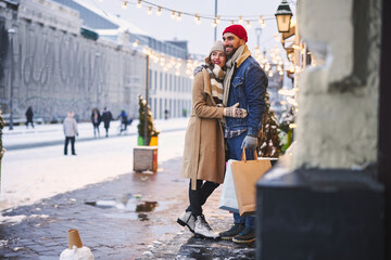Happy young couple dating in lighted winter city