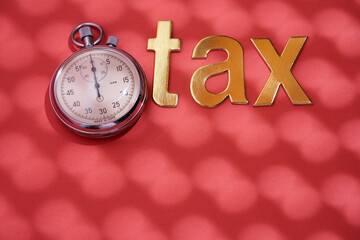 stop watch and single word tax on red background