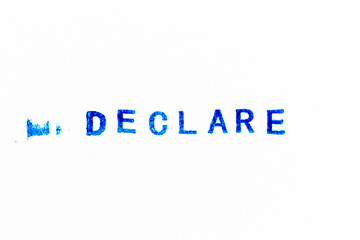Blue color ink of rubber stamp in word declare on white paper background