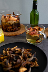 Composition of tea drinking. On a dark background, tea with dried fruits, apples, honey and chocolate. Antiviral kit. Side view 