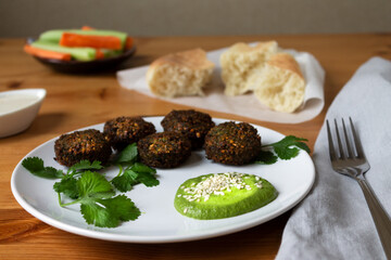 Protein lunch falafel vegetables carrots and celery bread tortilla and basil sauce