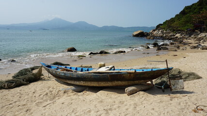 Fototapeta na wymiar a boat on a beach, Monkey Mountain, Son Tra Peninsula, Da Nang, Vietnam, February