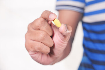 Close up of man hand holding pills with copy space 