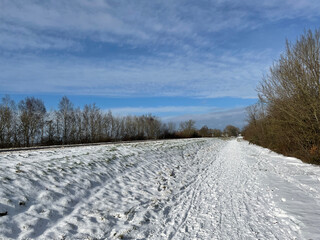 Fototapeta na wymiar Snowy bicyle path at the bridge over the Prinses Margriet canal