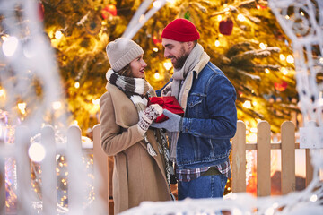 Obraz na płótnie Canvas Magic moments of loving couple at Christmas outdoors