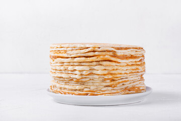 Waffle cake with butter cream and condensed milk against the white background. Homemade multi...