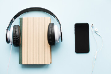 Headphones and book Audiobook concept