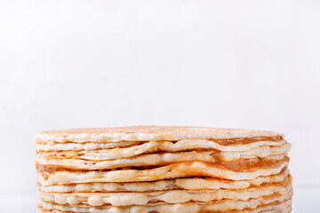 Waffle cake with butter cream and condensed milk against the white background. Homemade multi layered dessert