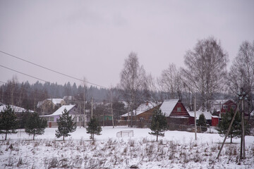  Wooden village houses in a snow-covered field.