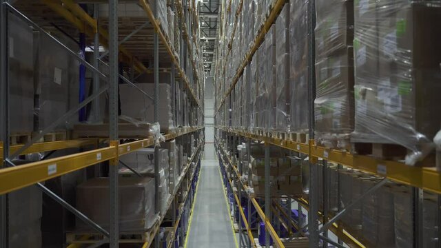 goods at the warehouse. rows shelves with cardboard boxes. Industrial storage room with boxes. Logistics center interior full of racks with with large number packs.