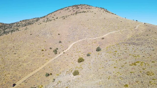 Cinematic aerial shot of ATV buggy driving in Death Valley, California