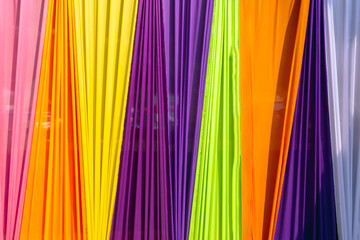 Beautiful multi-colored curtains decorated as a backdrop for the Buddhist ceremonies in Southeast Asia. Fabric colour and texture swatches. Background of colorful curtains hangs seamlessly together.
