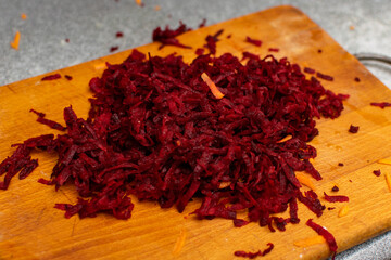 Grated beets on a cutting board.
