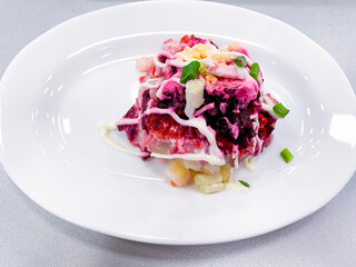 White plate with beetroot vegetable salad. Photo