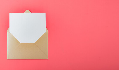 Opened gold envelope with white paper on a red background.