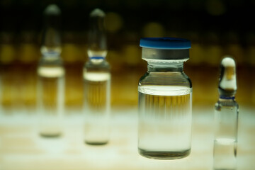 Abstract of vial, blurred brown ampules background 