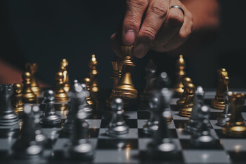 Hand of businessman playing chess figure in competition strategy management and leadership concept © prasertpr