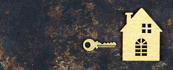 Buy new home, real estate concept, gold key and wooden house shape, web banner with copy space