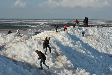Drifting ice in the winter people and children having fun © trinetuzun