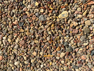 Decorative wall of small multi-colored pebbles. Photo