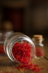 Saffron spices stems threads in a jar . Saffron flavor and coloring seasoning ingredient.