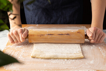 Woman going to bake, rolling dough. Home cooking. Sustainable consumption food